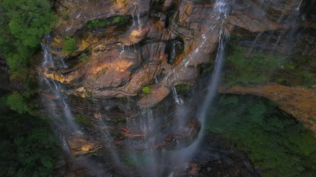 Aerial Descent: Beautiful Waterfall on Stunning Cliff Wall Among Lush Green, Blue Mountains, Australia