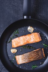 Grilled Salmon Steaks in Frying Pan with Garlic and Rosemary