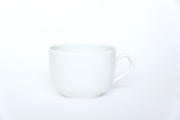 White tea cup isolated on white background side view with handle.