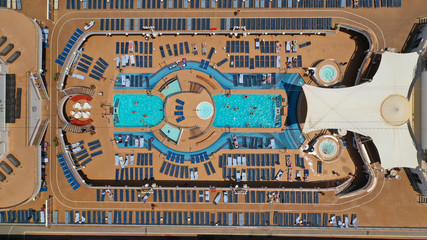 Aerial top view photo of cruise liner docked in popular Mediterranean destination port