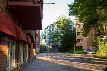Street in the Finnish city of Turku with a large granite stone between two residential buildings