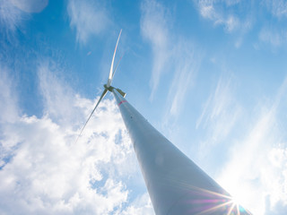 Wind turbine with blue sky and clouds