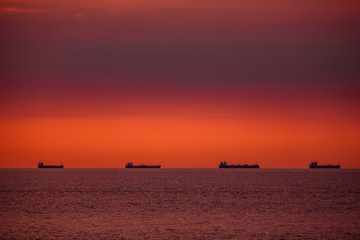 Energy import on waterway. Cargo ships on a ship route on the open sea in the evening light.