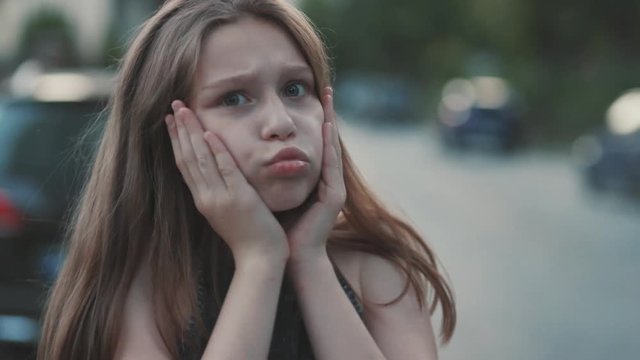 Shocked little girl looking at camera. Big eyes. Beautiful female teenager Close-up. Summertime. Blurred background. Emotions. Concept, idea, Caucasian, Slavic, Ukrainian, friendly, amicable