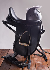 Black professional  leather dressage saddle in complete with riding helmet and gloves  puted at...