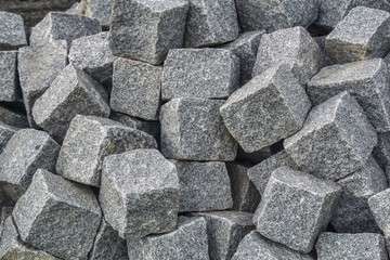 A mound of granite blocks used to build roads, squares, sidewalks, passages. A durable building material, laying paving stones requires strength and skill