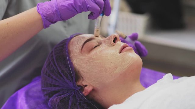 Close up of girl face during the procedure bb glow. Beauty concept. Face cosmetic procedure