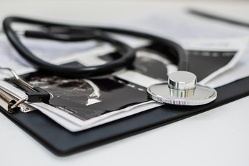 Medical stethoscope and patient’s card close up. Medical insurance concept. Health care and treatment concept.
