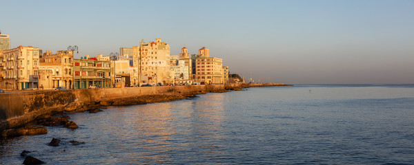 Fototapeta premium Beautiful panoramic view of the Old Havana City, Capital of Cuba, by the Ocean Coast during a vibrant sunny sunrise.