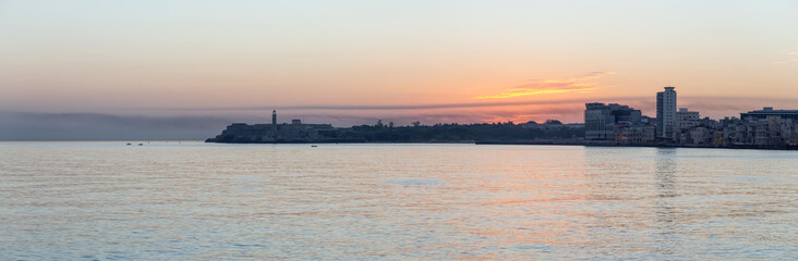 Beautiful Panoramic view of the Old Havana City, Capital of Cuba, during a colorful cloudy sunrise.