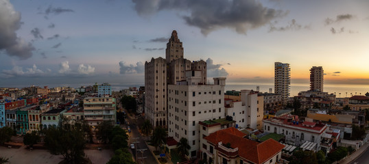 Naklejka premium Aerial Panoramic view of the Havana City, Capital of Cuba, during a colorful cloudy sunrise.