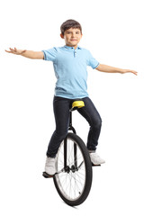 Male kid riding a unicycle and balancing with hands © Ljupco Smokovski