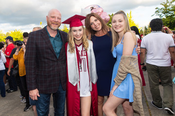 Happy family of four celebrating high school graduation