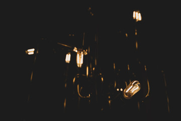 Dim vintage lightbulbs glowing with visible filament