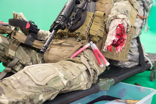 Mannequin Of A Wounded Fighter With A Severe Wound On A Stretcher. Medicine