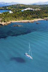 View from above, stunning aerial view of a sailing boat floating on a beautiful turquoise clear...