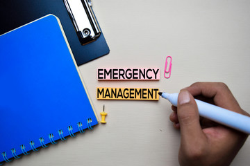 Emergency Management text on sticky notes with office desk concept