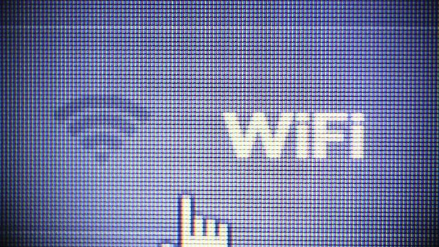 Pointing on Wifi icon on computer display. Wifi communication data transfer