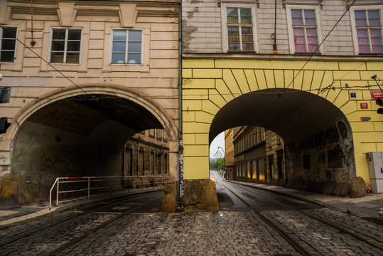 Prague, Czech Republic: The tunnel in the house. Unusual dorga with an arch for cars. Beautiful building in the historical center of Prague