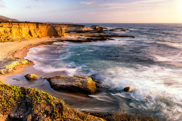 Sunset over Beach and Waves along Coastline
