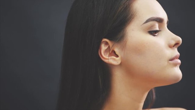 Close-up portrait. The beauty of a woman is a person. Beautiful young model with soft, smooth skin and professional makeup of the face. Portrait of a sexy girl with long eyelashes and perfect makeup.