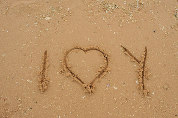 I love you on the sand of beach with wave and sunlight