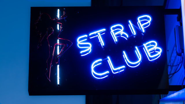 Girls strip club blue neon sign and woman silhouette
