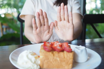 Women who control weight pushed the dessert plate away. diet concept