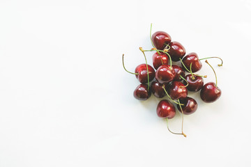 Obraz na płótnie Canvas Ripe red sweet cherries on pink background. Flat lay style. Diet and healthy food concept.