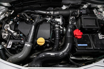 Fototapeta premium Close up detail of new car engine. Internal combustion engine, car parts, deteyling, Soft focus. Repair and transportation concept