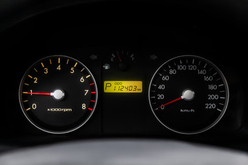 Fototapeta premium Car dashboard wuth red backlight: Odometer, speedometer, tachometer, fuel level, water temperature and more. Modern car interior: parts, buttons, knobs..