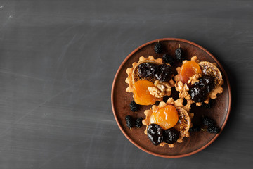 mouth-watering pastry cupcake with fruit and nuts. Muffin with dried apricots prunes walnut