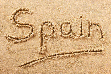 Spain word written in sand on a sunny spanish summer beach holiday vacation travel destination sign writing message photo