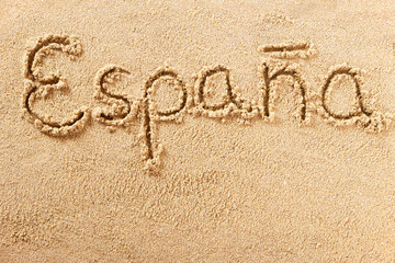 Espana spain word written in sand on a sunny spanish summer beach holiday vacation travel destination sign writing message photo