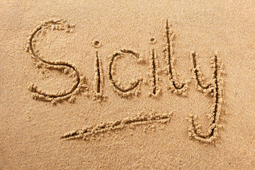 Sicily italy word written in sand on a sunny italian island summer beach holiday vacation travel destination sign writing message photo