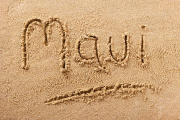 Maui word written in sand on a sunny hawaii hawaiian summer beach holiday vacation travel destination sign writing message photo