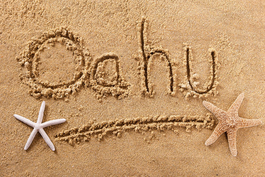 Oahu word written in sand on a sunny hawaii hawaiian summer beach with starfish holiday vacation travel destination sign writing message photo