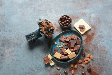 Black and brown milky chocolate bars and almond nuts for dessert