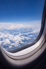 Fototapeta na wymiar Beautiful scenery of sky and white clouds looking from window on airplane