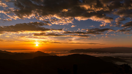 landscape silhouette mountain fog and the sunset with  background at morning time in Thailand