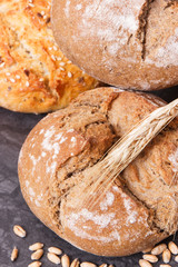 Wholegrain rolls or bread with seeds and ears of rye grain