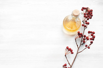 Rennet apple essential oil on a wooden board background.