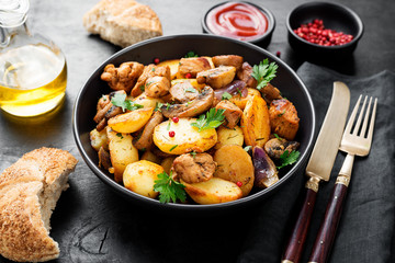 Baked potatoes with meat and mushrooms served with fresh salad and bread bun.
