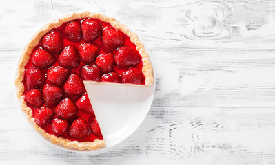 Delicious strawberry tart on white wooden background, top view