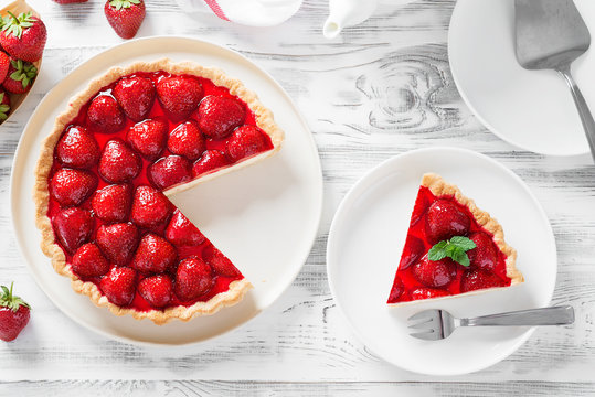 Delicious strawberry tart on white wooden background, top view