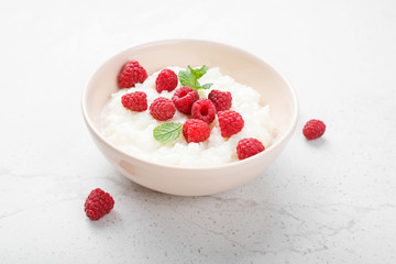 Delicious rice pudding with raspberry and mint leaf.
