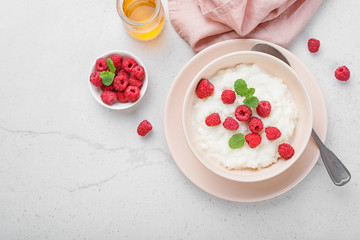 Delicious rice pudding with raspberry and mint leaf.