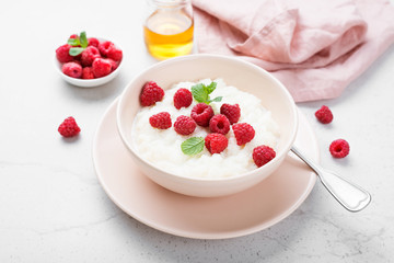Delicious rice pudding with raspberry and mint leaf.