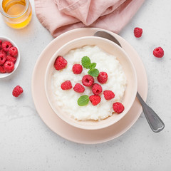 Delicious rice pudding with raspberry and mint leaf.