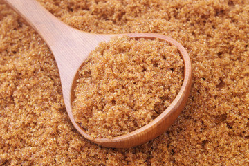 Wooden spoon and dark brown sugar
